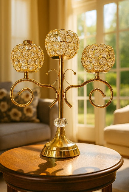 Decorative gold candle holder with crystal accents on a table in a living room.