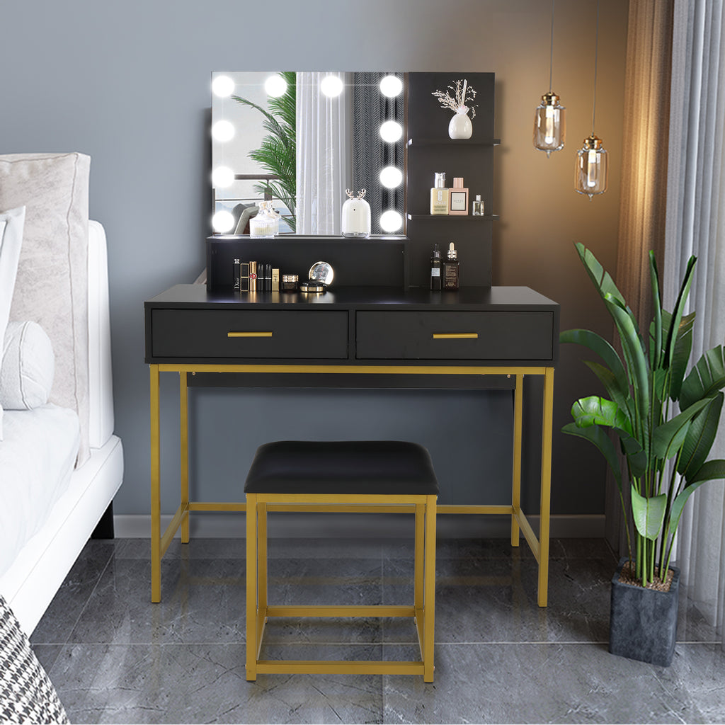 Black vanity table with mirror and stool in a bedroom setting